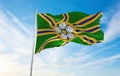 flag of Abbotsford, British Columbia , Canada at cloudy sky background on sunset, panoramic view. Canadian travel and patriot