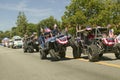 Flag adorned jeeps demonstrate 4 wheel maneuvers as they make their way down main street during a Fourth of July parade in Ojai