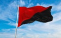 flag of Anarchism at cloudy sky background on sunset, panoramic view. Anarchism symbol.. copy space for wide banner. 3d