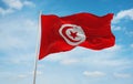 flag of Arab peoples Tunisians at cloudy sky background, panoramic view.flag representing ethnic group or culture, regional Royalty Free Stock Photo