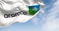Flag of Aramco oil company waving in the wind