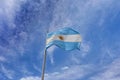 Flag of Argentina against a blue and white sky