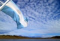 Flag of Argentina of a cruise ship waving in the sunlight against bright cloudy sky Royalty Free Stock Photo