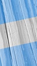 Flag of Argentina on dry wooden surface, cracked with age. Vertical background or mobile phone wallpaper with Argentine national Royalty Free Stock Photo