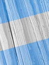 The flag of Argentina on dry wooden surface, cracked with age. Vertical background, wallpaper or backdrop with Argentine national Royalty Free Stock Photo