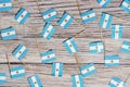 Flag of Argentina hanging on clothesline attached with wooden clothespins on aqua blue wooden background. National day concept