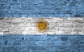 Flag of Argentina over an old brick wall background, surface Royalty Free Stock Photo