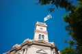 Flag of Argentina waving over clock tower against blue sky on the building of Legislature of the Province of Cordoba Royalty Free Stock Photo