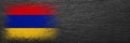 Flag of Armenia. Flag is painted on black slate stone. Stone background. Copy space. Textured background