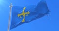 Flag of Asturias waving at wind with blue sky, loop