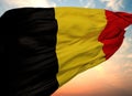 Flag of Belgium waving in the wind with sunset sky background, close-up Royalty Free Stock Photo
