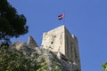 Flag blows over tower of old fortress in Croatia