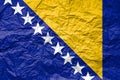 Flag of Bosnia and Herzegovina on crumpled paper. Textured background Royalty Free Stock Photo