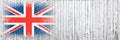 Flag of Britain. Flag is painted on a white wooden surface. Wooden background. Plywood surface. Copy space. Textured background Royalty Free Stock Photo