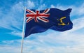 flag of British Royal Fleet Auxiliary Ensign at cloudy sky background on sunset, panoramic view. united kingdom of great Britain