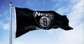 Flag of Brooklyn Nets waving in the wind on a clear day