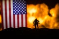 Flag on burning dark background. Concept of crisis of war and political conflicts between nations. Selective focus