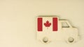 Flag of Canada on the recycled cardboad truck icon, national sustainable logistics concept