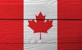 Flag of Canada on wooden wall background. Grunge Canadian flag texture. Royalty Free Stock Photo
