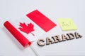 Flag of Canada, word Canada in wooden abstract letters, sticker with the inscription yes. White background Royalty Free Stock Photo