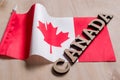 Flag of Canada, the word Canada in wooden abstract letters, wooden background Royalty Free Stock Photo