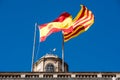 Flag of Catalonia. Senyera. Red and yellow striped flag and flag of Spain on clean blue sky background. Flag waving in the wind in