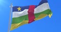 Flag of the Central African Republic waving at wind with blue sky, loop