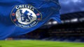 The flag of Chelsea Football Club waving inside the Stamford Bridge stadium at night