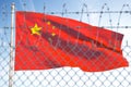 Flag of China behind barbed wire fence. Concept of sanctions, embargo, dictatorship, discrimination and violation of human rights