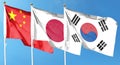 Flag of China and flag of Japan and South Korea. Flying on the cloudy sky Royalty Free Stock Photo