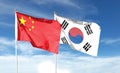 Flag of China flag and South Korea. Flying flag on the cloudy sky. waving in the sky Royalty Free Stock Photo