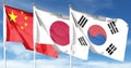 Flag of China and flag of Japan and South Korea. Flying on the cloudy sky Royalty Free Stock Photo