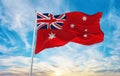 flag of Civil Ensign of Australia , Australia at cloudy sky background on sunset, panoramic view. Australian travel and patriot