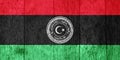 Flag and coat of arms of State of Libya on a textured background. Concept collage Royalty Free Stock Photo