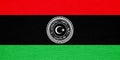 Flag and coat of arms of State of Libya on a textured background. Concept collage Royalty Free Stock Photo