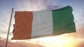 Flag of Cote d`ivoire waving in the wind, sky and sun background. 3d rendering Royalty Free Stock Photo