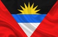 Flag of the country of Antigua and Barbuda on a background of wavy silk fabric Royalty Free Stock Photo