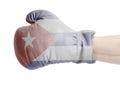 Flag of Cuba on boxing gloves wearing in male hand Royalty Free Stock Photo
