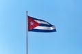 Flag of Cuba flying against blue sky Royalty Free Stock Photo