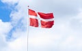 flag of denmark in a blue sky with clouds