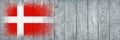Flag of Denmark. Flag is painted on a gray wooden plank surface. Wooden background. Plywood surface. Copy space. Textured Royalty Free Stock Photo