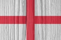 The flag of England on a dry wooden surface, cracked with age. It seems to flutter in the wind. Background, wallpaper or backdrop Royalty Free Stock Photo