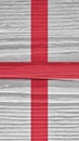 The flag of England on a dry wooden surface, cracked with age. It seems to flutter in the wind. Mobile phone wallpaper with Royalty Free Stock Photo