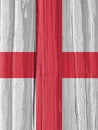 The flag of England on a dry wooden surface, cracked with age. It seems to flutter in the wind. Vertical illustration with Royalty Free Stock Photo