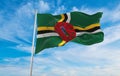 flag of English Creole peoples Dominicans at cloudy sky background, panoramic view. flag representing extinct country,ethnic group