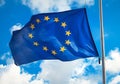Flag of the European Union against a blue cloudy sky. Royalty Free Stock Photo