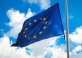 Flag of the European Union against a blue cloudy sky. Royalty Free Stock Photo