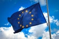 Flag of the European Union against a blue cloudy sky. Royalty Free Stock Photo