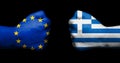 Flag of European Union and Greece painted on two clenched fists Royalty Free Stock Photo