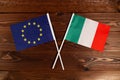 Flag of European Union and flag of Italy crossed with each other. The image illustrates the relationship between countries